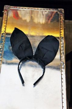 a close up of a black headband on top of a metal box with a painting in the background