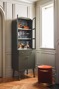 a cabinet with many items on it in a room