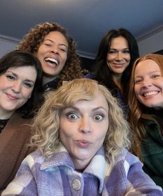 a group of women standing next to each other with their mouths open and making funny faces