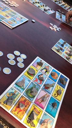 the game is being played on the table with several different cards and token pieces scattered around it