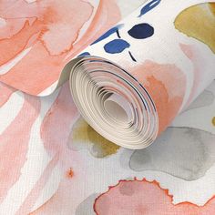 a wallpaper with watercolor flowers on it and a roll of paper next to it