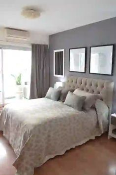 a large bed sitting in the middle of a bedroom