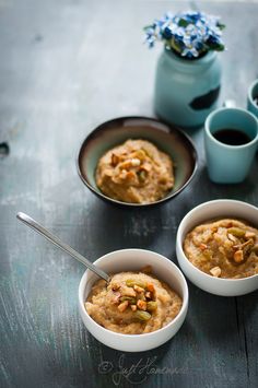 three bowls filled with oatmeal sitting on top of a table