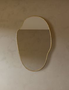 a mirror hanging on the wall in a room with beige walls and white flooring