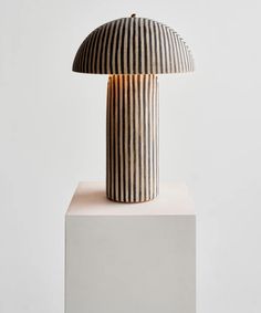 a black and white lamp sitting on top of a block