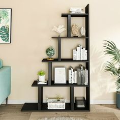 a living room with a blue couch and bookshelf in the corner next to a plant