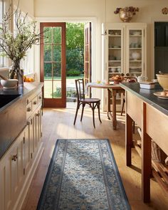 a kitchen with an area rug on the floor