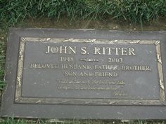 a plaque in the grass that says john s riter, beloved husband father brother son and friend