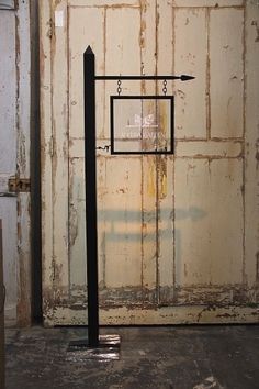 an old door with a basketball hoop hanging from it's side in the corner