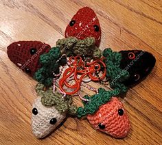 several crocheted animals are laying on the floor