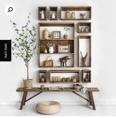 a wooden table topped with shelves filled with vases and plants