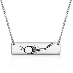 a silver necklace with an image of the sun on it