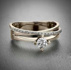 a wedding ring with a diamond in the center and an engagement band on each side