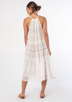 An elegant bohemian swim cover-up dress. Designed in sheer cotton gauze with mixed lace panels. Swim cover-up Mixed media Relaxed, flowy fit Sleeveless Mid-length Tiered body Drawstring halter neckline Tie shoulder Sheer Bohemian cotton midi dress Elevate your beach wardrobe with this ultra-pretty swim cover-up. A dreamy midi dress style featuring an adjustable drawstring halter neckline, a flattering flowy sheer silhouette, and a tiered body for extra shape and movement. Model is 5'9, wearing a Airy Flowy Dress For Beach Cover-up, Bohemian Lace Patchwork Summer Cover-up, Summer Sheer Lace Maxi Dress, Sheer Lace Summer Dress, Breezy Sleeveless Beach Dress For Beach Wedding, Summer Sheer Lace Dresses, Breezy Sleeveless Beach Dress For Wedding, Sheer Lace Dress For Summer, Flowy Boho Dress With Lace Trim For Beach