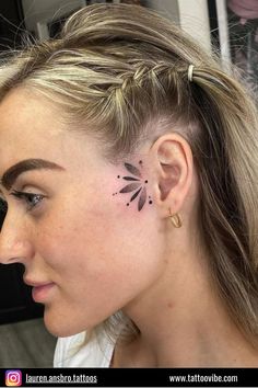 a woman with a flower tattoo on her left side of her ear and behind her ear