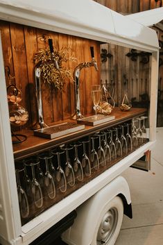 an old truck with wine glasses on the back