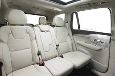 the interior of a car with white leather seats