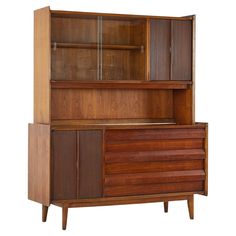 a wooden cabinet with glass doors and drawers on it's sides, against a white background