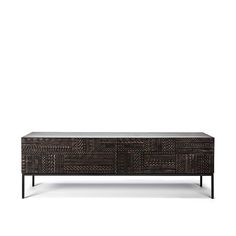 the sideboard is made out of rattan and has black metal legs, which are accented with woven fabric