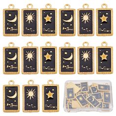 twelve gold and black charms with stars, crescents and moon on them in a plastic container