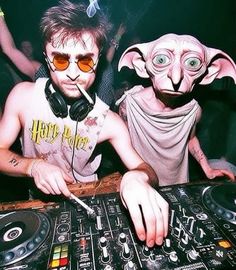 two people wearing masks and headphones at a dj booth