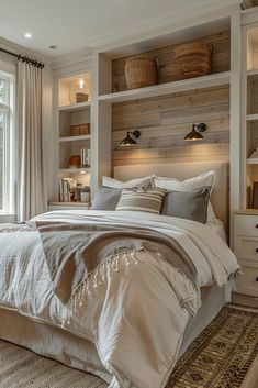 a large bed sitting in a bedroom next to a window with lots of shelves above it