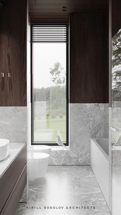 a bathroom with marble walls and flooring next to a bathtub in front of a large window