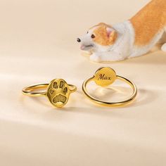 a dog's paw is shown next to two rings with the name max on them