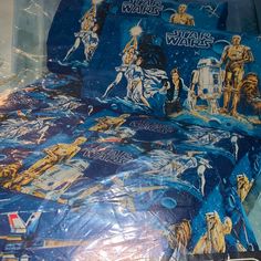 a bed with star wars on it and blue sheets