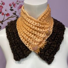 a white mannequin wearing a brown and tan crochet cowgirl neck scarf