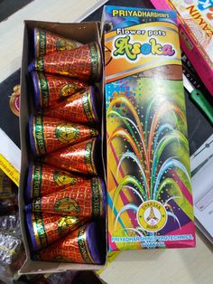 an open box of fireworks are sitting on a table