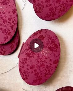 pink paper plates with floral designs are arranged on a white tablecloth and the video is being recorded