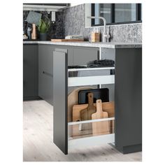 an image of a kitchen setting with cutting boards and knives in the cabinet drawer space