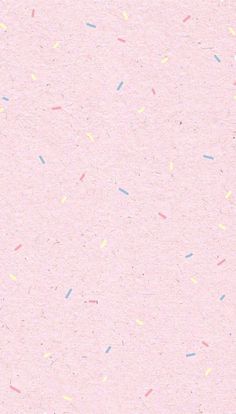 a pink background with multicolored sprinkles