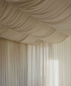 a room with white drapes covering the walls