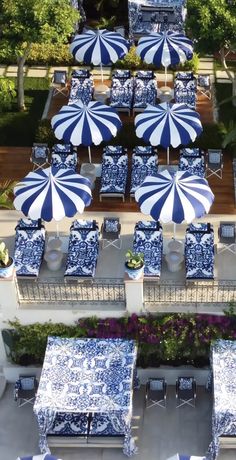 an aerial view of blue and white tables and umbrellas