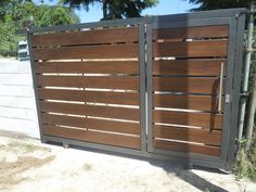 a wooden gate with metal bars on it