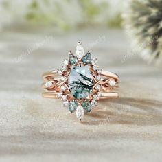 a close up of a ring with an aqua and white stone in the center on a table