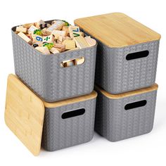 three storage bins stacked on top of each other with dice and blocks in them