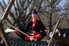 a young woman is practicing yoga in the park