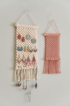 two wall hangings with earrings on them