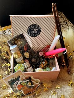 a box filled with lots of different items on top of a fur covered tablecloth