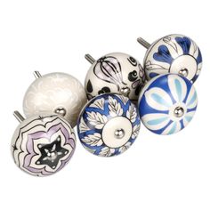 a bunch of different colored knobs on a white surface with black and blue designs