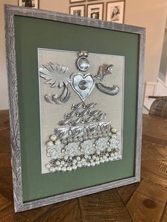 a frame with some pictures on it and a heart in the middle, surrounded by other frames