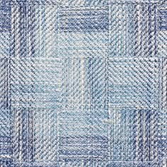 a blue and white rug with squares in the middle, on top of each other