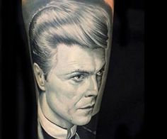 a man's arm with a portrait of the actor, james bond on it