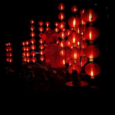 many red lanterns are lit up in the dark