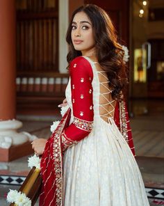 a beautiful woman in a white and red dress