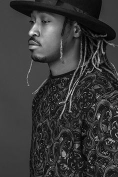 a man with dreadlocks wearing a black hat