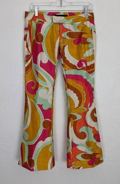 "✰ Rare Miss Sixty Pucci Style  ✰ Polyester material gives good structure. No stretch ✰ Sassy bell cropped capris would look great with some platforms ✰ 2 front coin pockets and 2 back faux pockets Circa: 2000s Material: 100% polyester Label: Miss Sixty, made in Italy - MEASUREMENTS- (measurements taken flat) please refer to listing images for how we measure Label size: 25 Waist: 15\" (please note that these are low-rise and sit closer to the hip bones and not the true waist) Hip: 18.5 Length: 3 Groovy Flare Stretch Bottoms, Multicolor Flare Cotton Bottoms, Multicolor Cotton Flare Bottoms, Retro Stretch Flare Bottoms, Retro Flare Stretch Pants, Groovy Fitted Wide Leg Bottoms, Retro Multicolor Flare Bottoms, Fitted Wide Leg Capris For Spring, Retro Stretch Bottoms For Spring